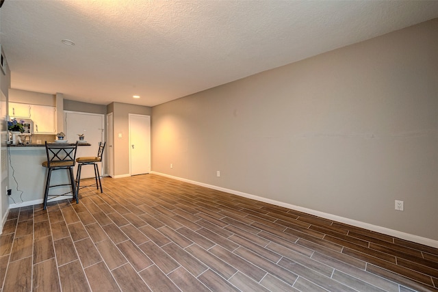 living room featuring a textured ceiling and dark hardwood / wood-style flooring