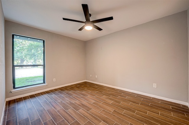 unfurnished room featuring ceiling fan and dark wood-type flooring