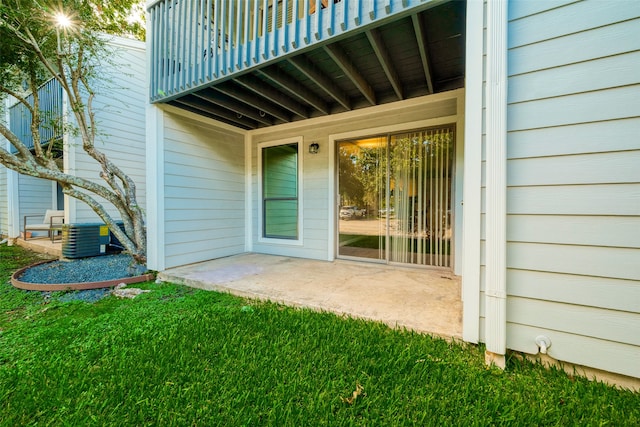 entrance to property featuring a yard and a patio area