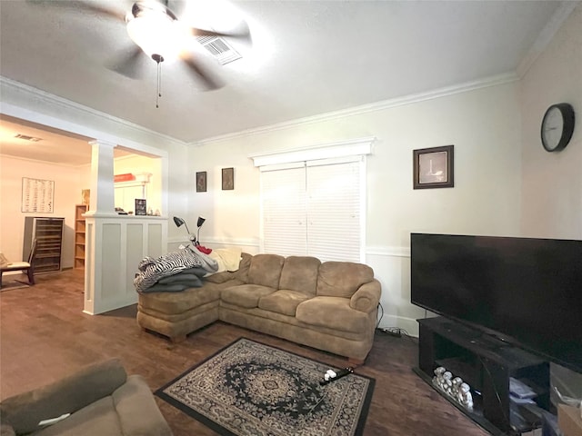 living room with ornate columns, crown molding, and ceiling fan