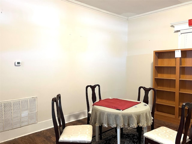 dining room with crown molding and dark wood-type flooring