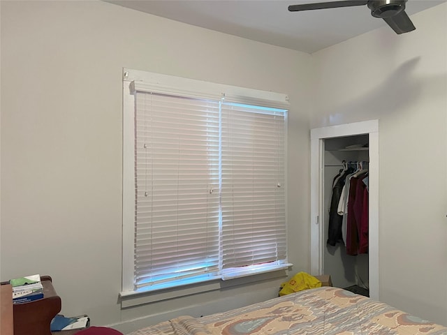 bedroom featuring ceiling fan and a closet