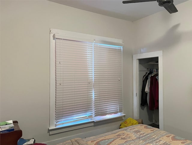 bedroom with ceiling fan and a closet