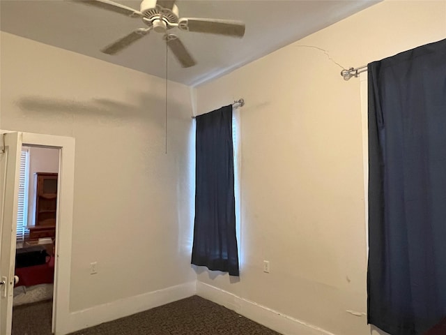 empty room featuring carpet and ceiling fan