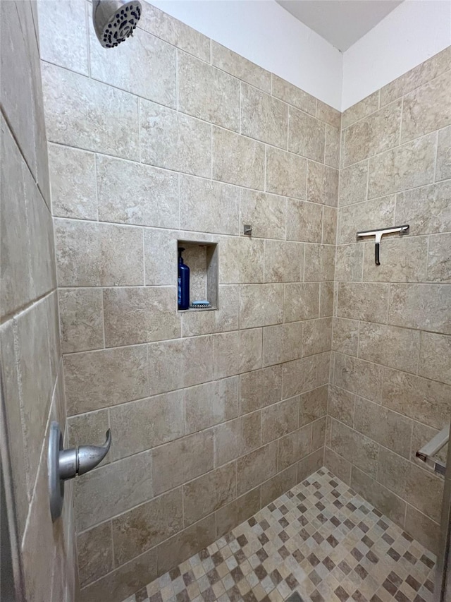 bathroom with a tile shower