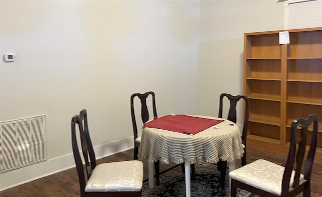 dining space with dark hardwood / wood-style flooring