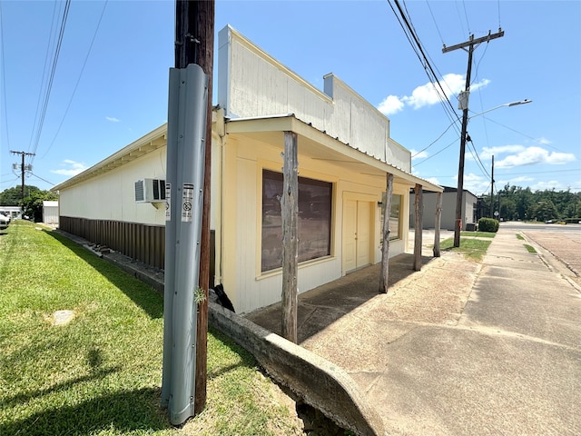 view of property exterior with a lawn