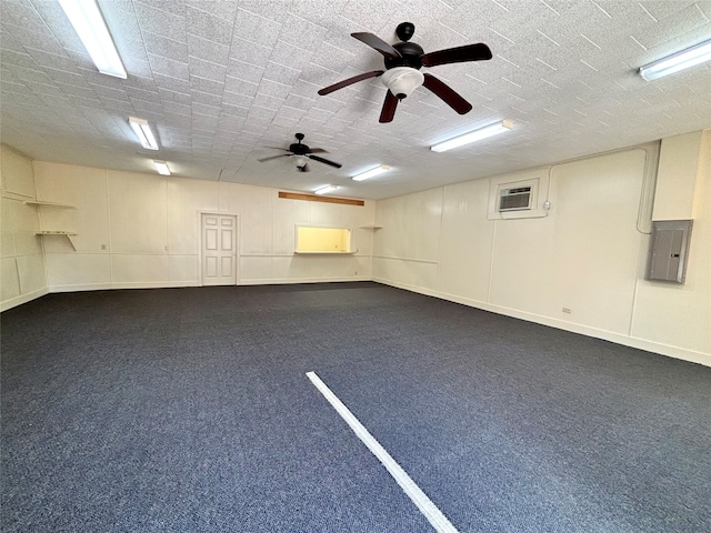 garage with a wall mounted AC, electric panel, and ceiling fan