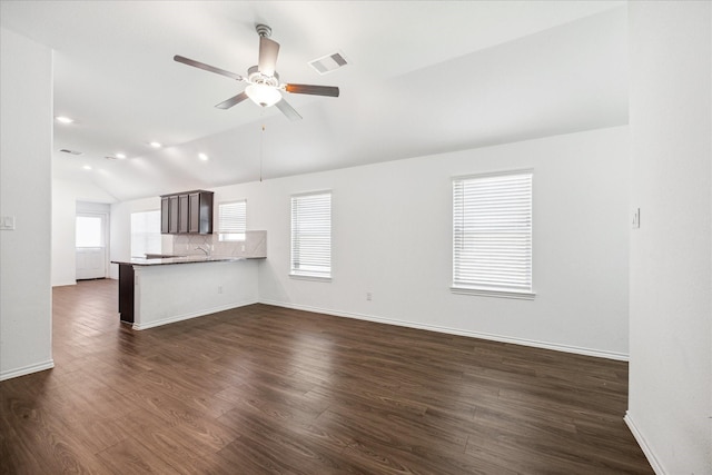 unfurnished living room with dark wood-type flooring, ceiling fan, lofted ceiling, and sink