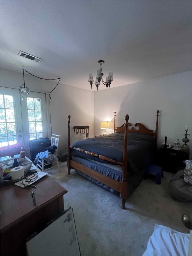 bedroom with a notable chandelier and carpet floors