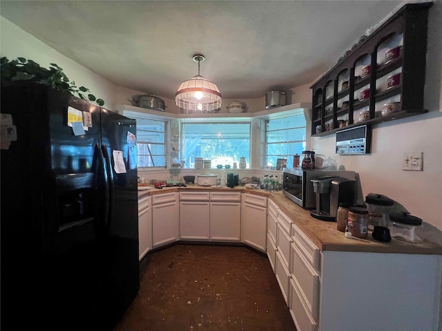 kitchen featuring white cabinets, butcher block counters, and black fridge with ice dispenser