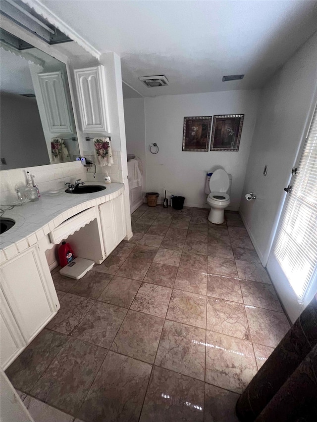 bathroom featuring vanity and toilet