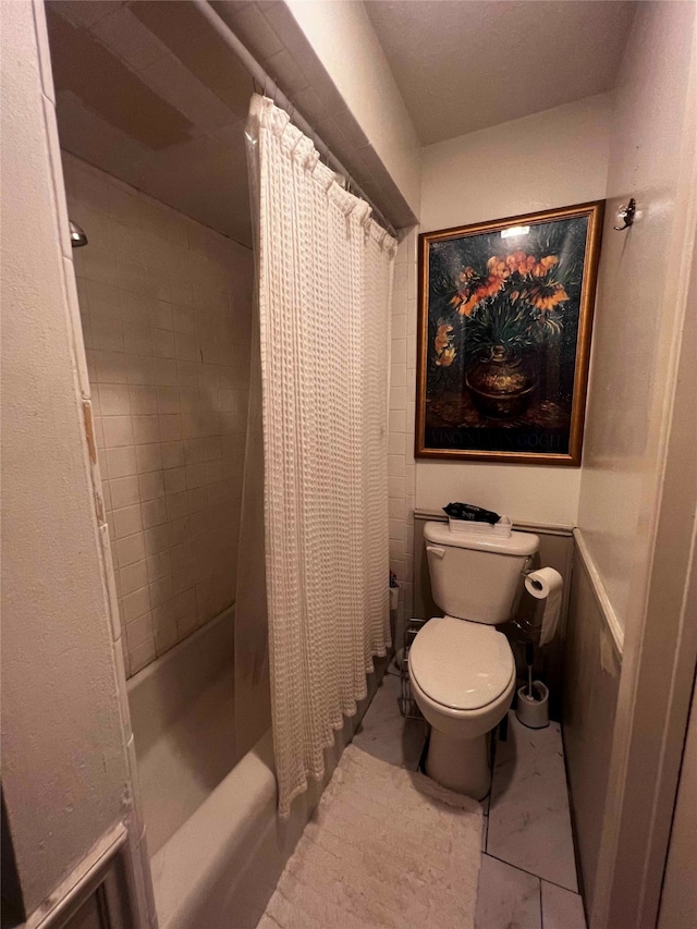 bathroom featuring toilet and shower / bath combination with curtain