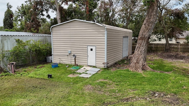 view of outbuilding with a yard