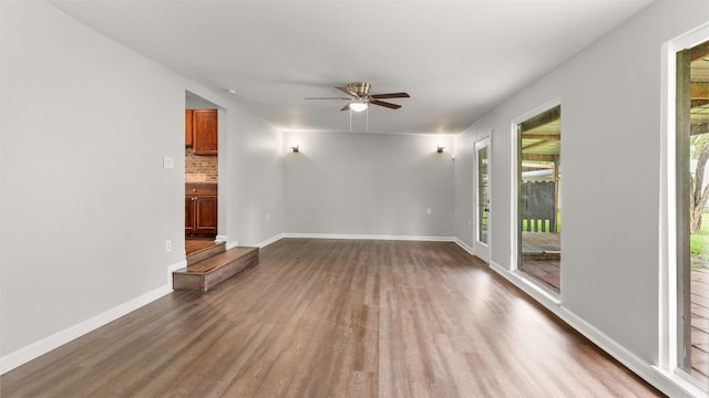 unfurnished living room featuring hardwood / wood-style floors, plenty of natural light, and ceiling fan