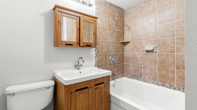 full bathroom featuring vanity, tiled shower / bath combo, and toilet