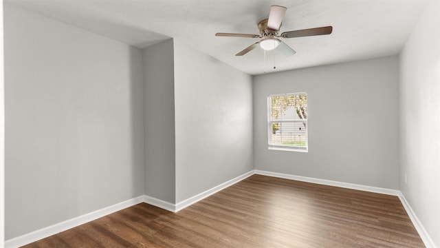 unfurnished room featuring dark wood-type flooring and ceiling fan