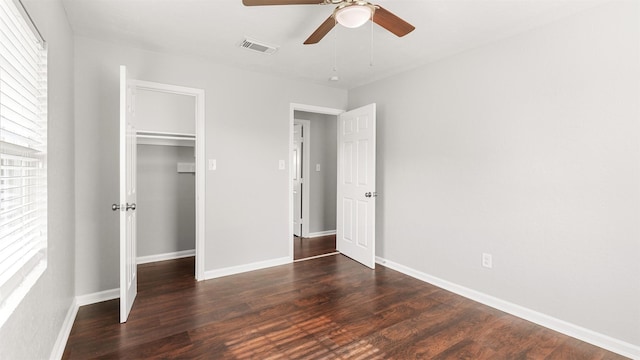 unfurnished bedroom featuring a closet, dark hardwood / wood-style floors, and ceiling fan