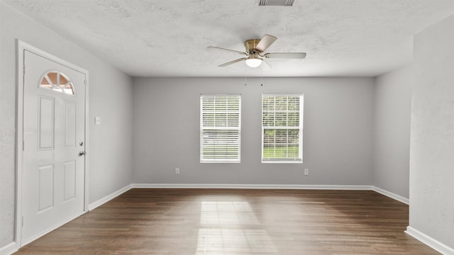 entryway featuring ceiling fan, dark hardwood / wood-style flooring, and a textured ceiling