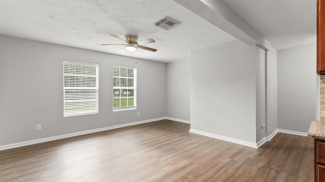 spare room featuring wood-type flooring and ceiling fan