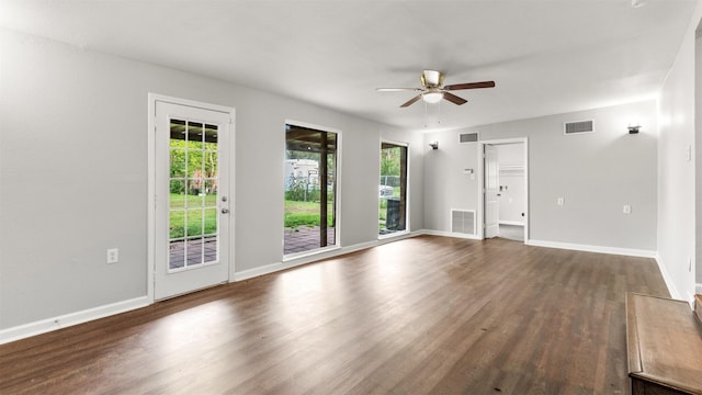 empty room with dark wood-type flooring and ceiling fan