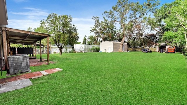 view of yard featuring cooling unit and a storage unit