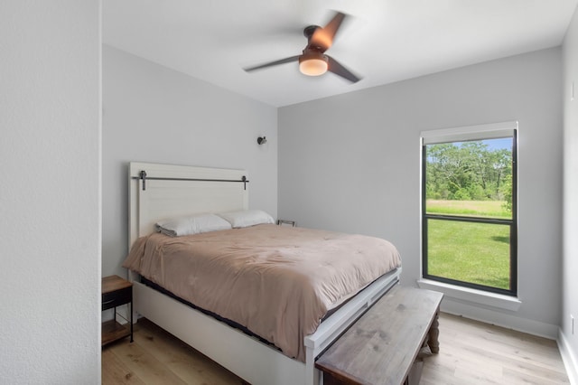 bedroom with ceiling fan and light hardwood / wood-style flooring