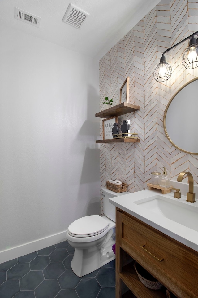 bathroom featuring tile patterned floors, vanity, and toilet