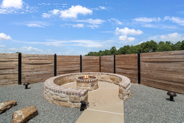 view of yard featuring an outdoor fire pit and a patio