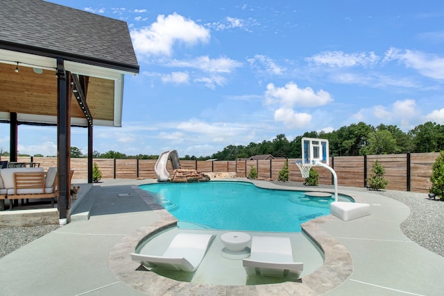 view of swimming pool featuring a patio area and a water slide