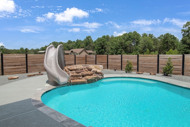 view of pool with a water slide