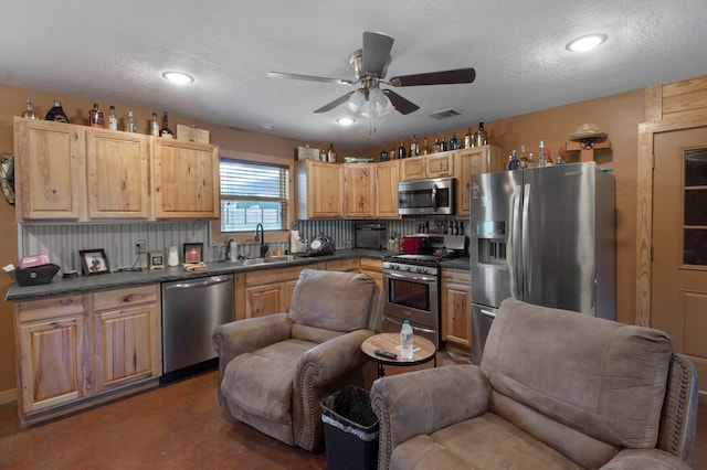 kitchen with ceiling fan, decorative backsplash, sink, appliances with stainless steel finishes, and light brown cabinetry