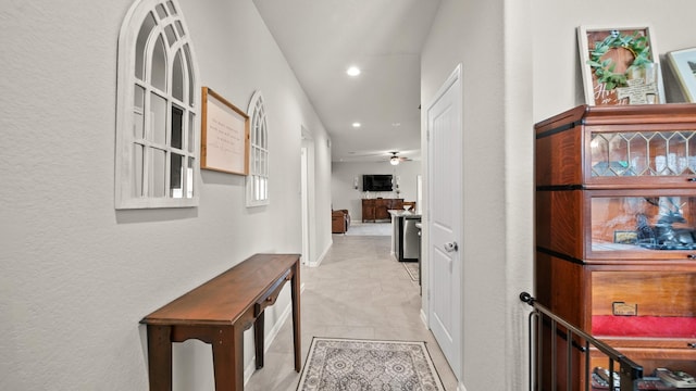 hall with light tile patterned floors