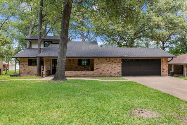 view of front of house featuring a garage and a front lawn