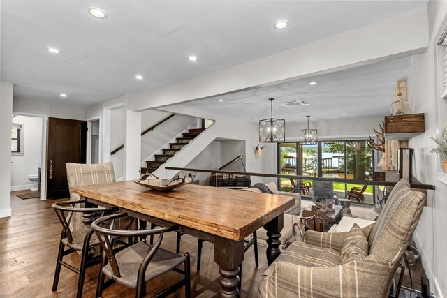 dining space with a chandelier and hardwood / wood-style flooring