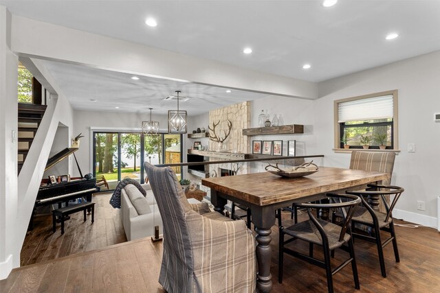 dining space with a chandelier and dark hardwood / wood-style floors