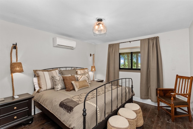 bedroom with a wall mounted air conditioner and dark wood-type flooring