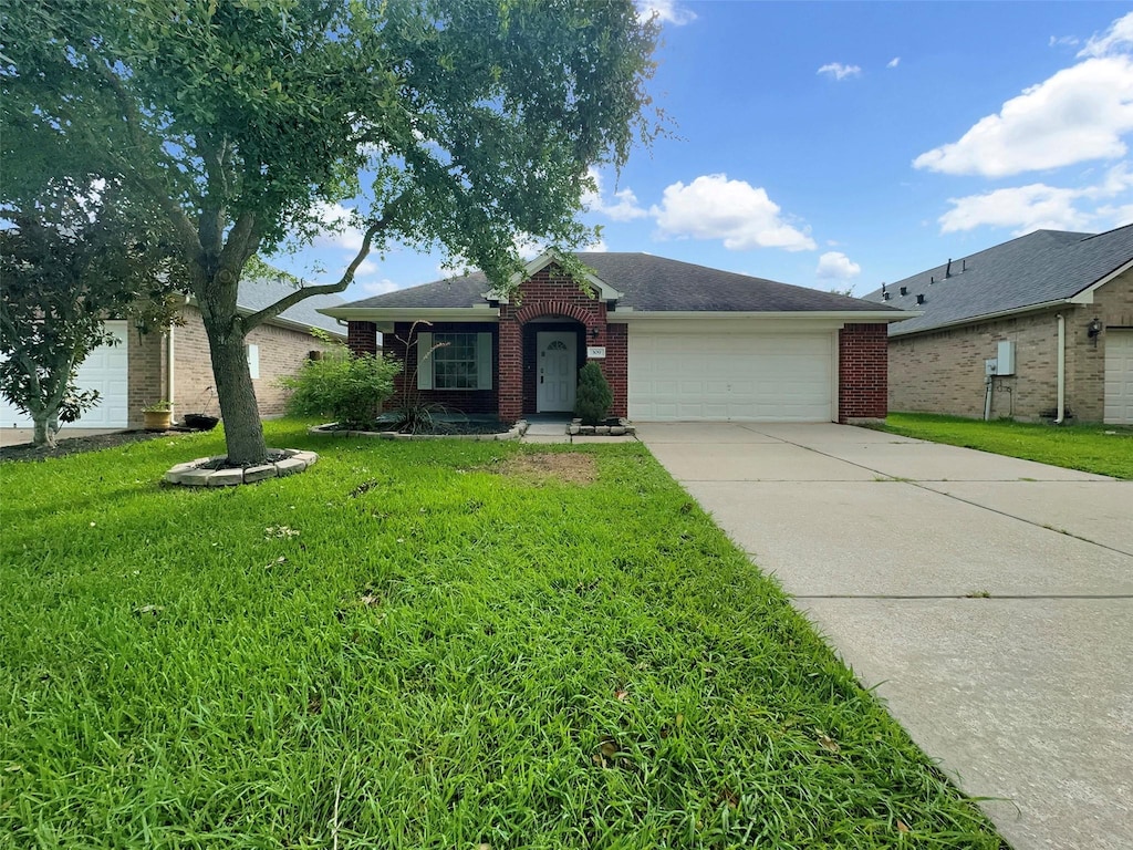 single story home with a front yard and a garage