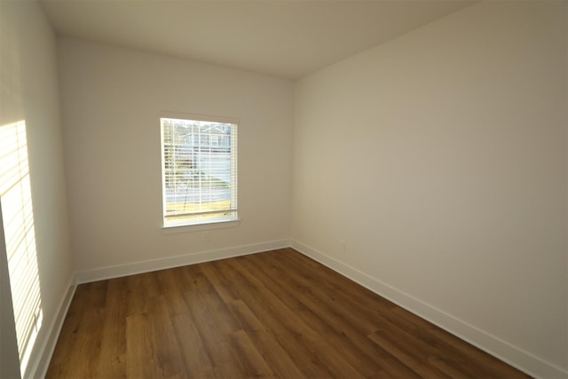 empty room featuring dark hardwood / wood-style flooring