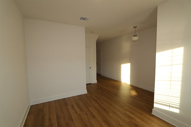 spare room featuring dark hardwood / wood-style flooring