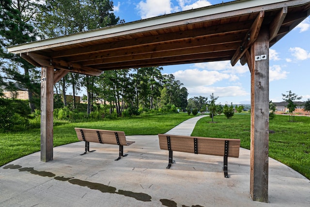 surrounding community with a patio and a yard