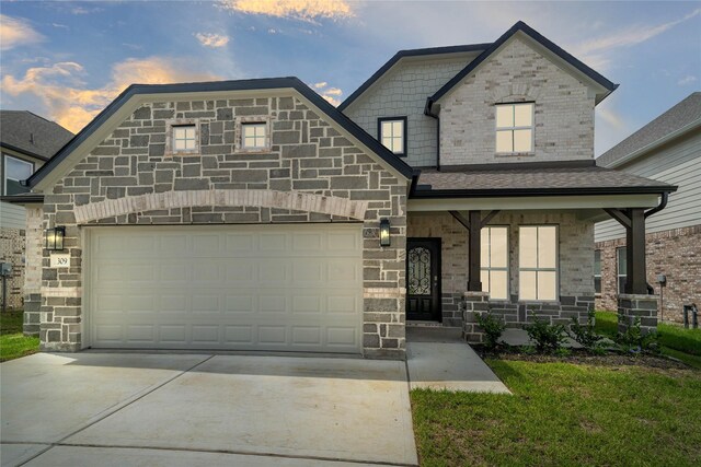 view of front of property featuring a garage and covered porch