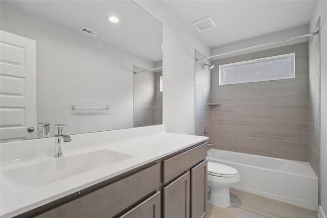 full bathroom featuring vanity, tiled shower / bath combo, and toilet