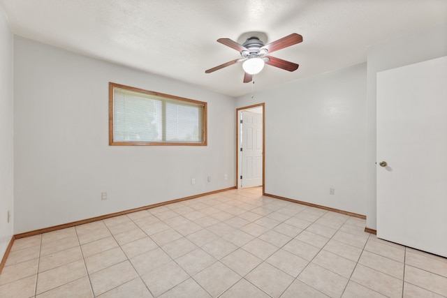 empty room with light tile patterned flooring and ceiling fan