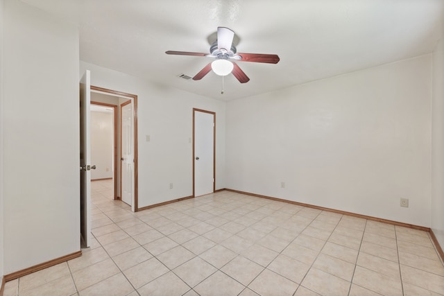 tiled empty room with ceiling fan