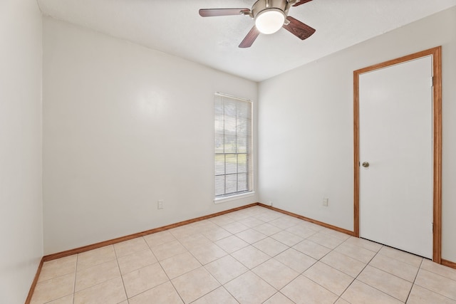 spare room with light tile patterned flooring and ceiling fan