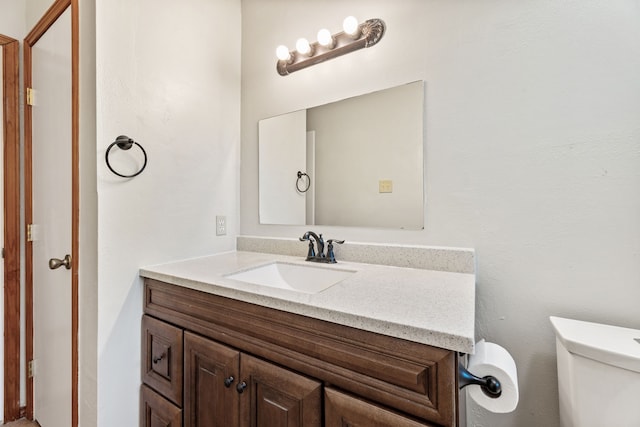 bathroom featuring toilet and vanity