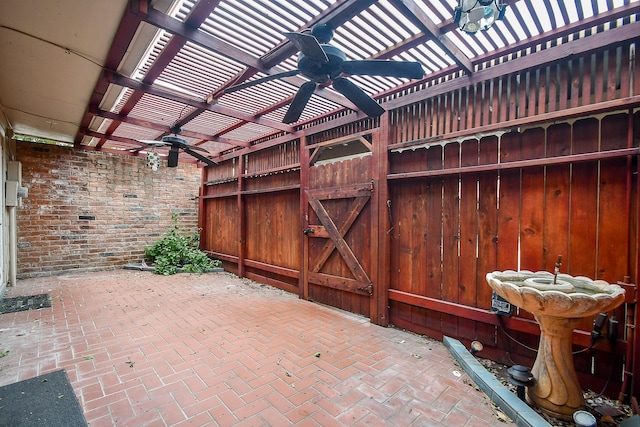 view of patio / terrace with ceiling fan and a pergola