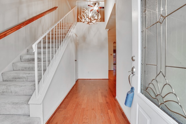 foyer entrance with a chandelier and light hardwood / wood-style flooring