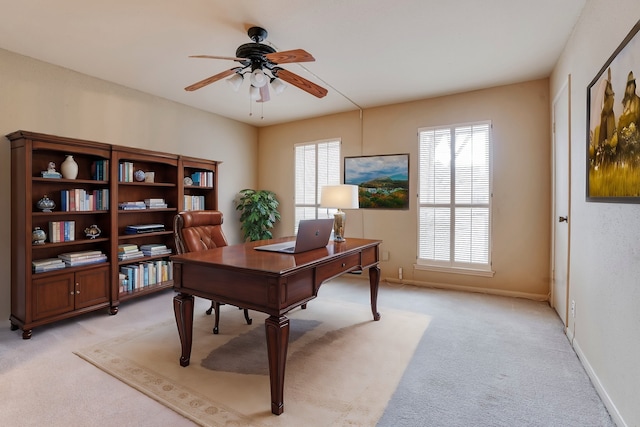 office space featuring ceiling fan and light colored carpet